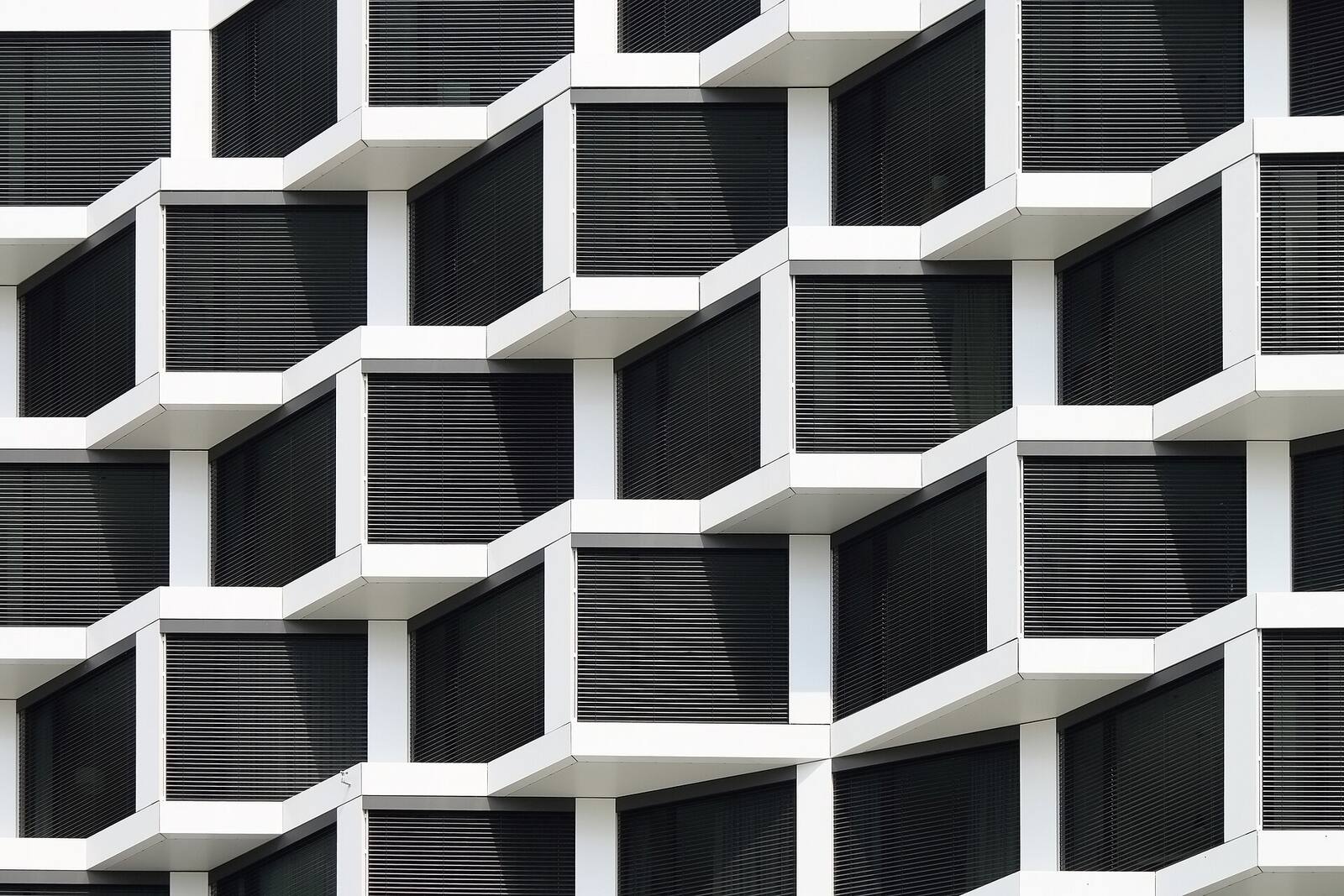 White facade of deep, offset window frames in a repeating grid